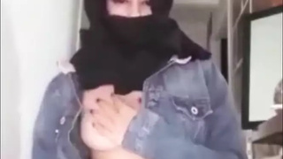 Arab wearing burqa and kneeling for her master