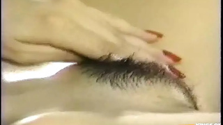 Pretty Thai Bitch Plays with Her Hairy Twat on the Bed