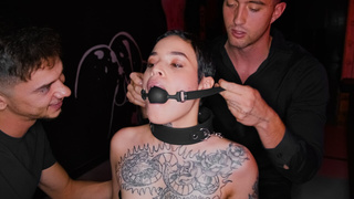 Obedient tattooed whore gets gagged and dominated by 2 rough dudes in BDSM style